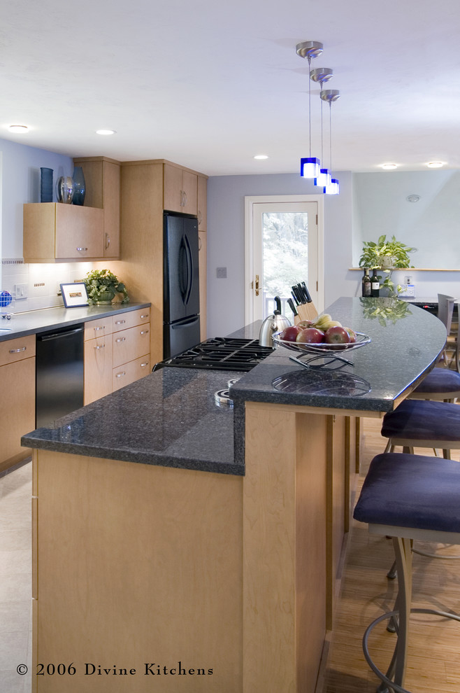 Inspiration for a large contemporary l-shaped eat-in kitchen in Boston with an undermount sink, flat-panel cabinets, light wood cabinets, granite benchtops, white splashback, ceramic splashback, black appliances, light hardwood floors and with island.