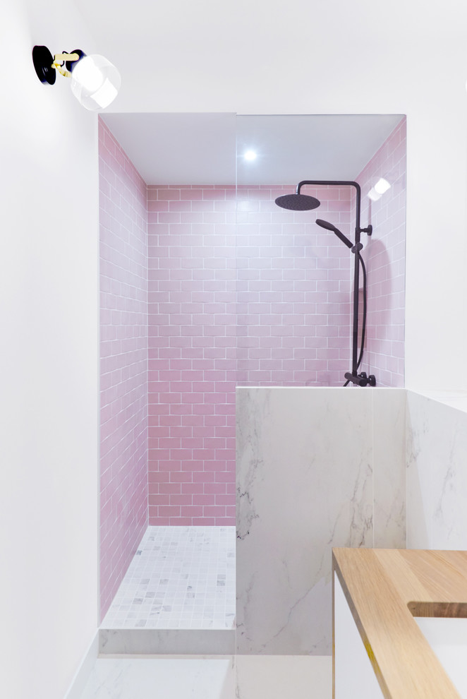 This is an example of a mid-sized contemporary 3/4 bathroom in Paris with beaded inset cabinets, brown cabinets, blue tile, cement tile, pink walls, marble floors, a trough sink, tile benchtops, white floor and white benchtops.