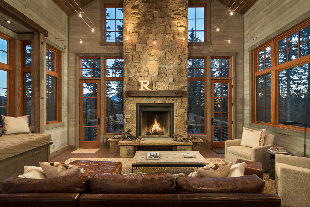 Design ideas for a mid-sized country open concept living room in Denver with dark hardwood floors, a standard fireplace, a stone fireplace surround, brown floor and brown walls.