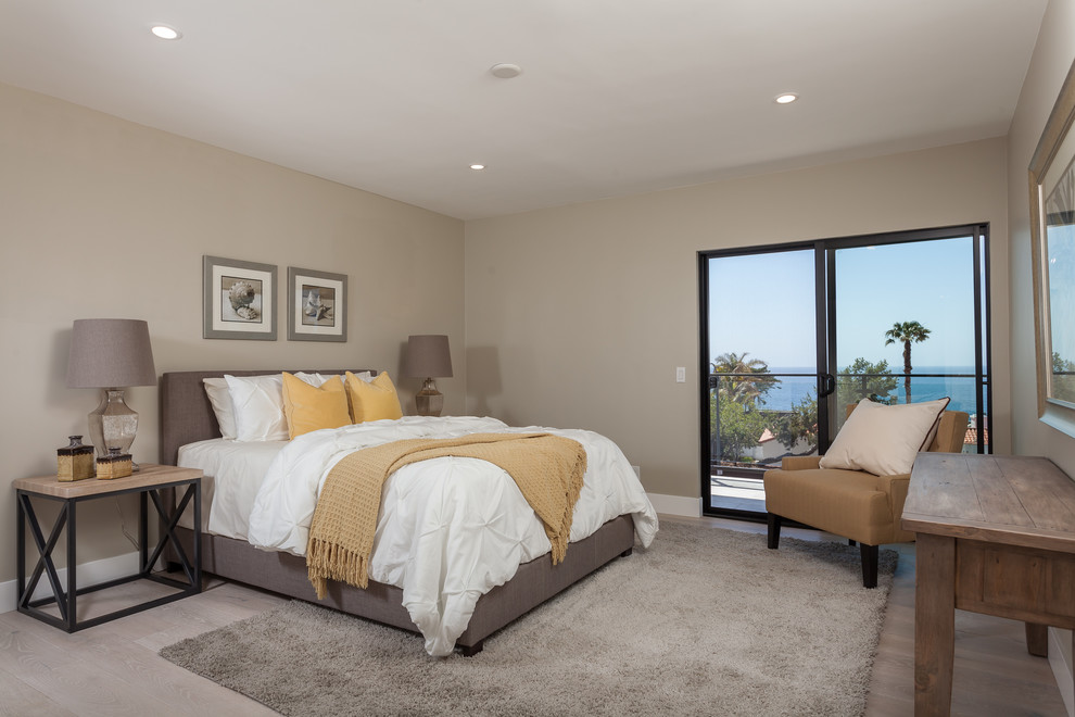 Photo of a large contemporary loft-style bedroom in Orange County with beige walls and porcelain floors.
