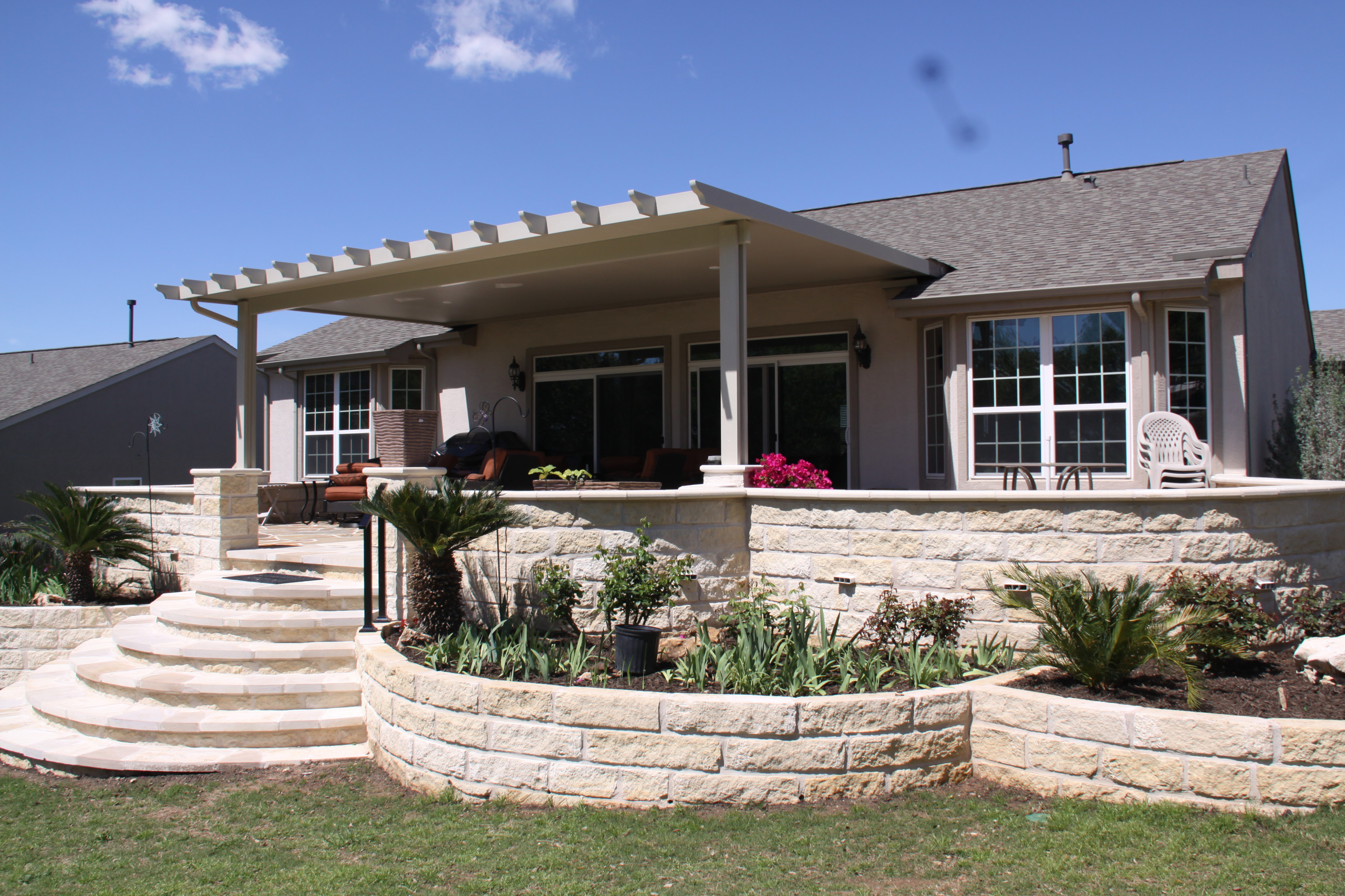 flagstone patio, limestone seatwalls and raised beds with "solid" Alumawood cano