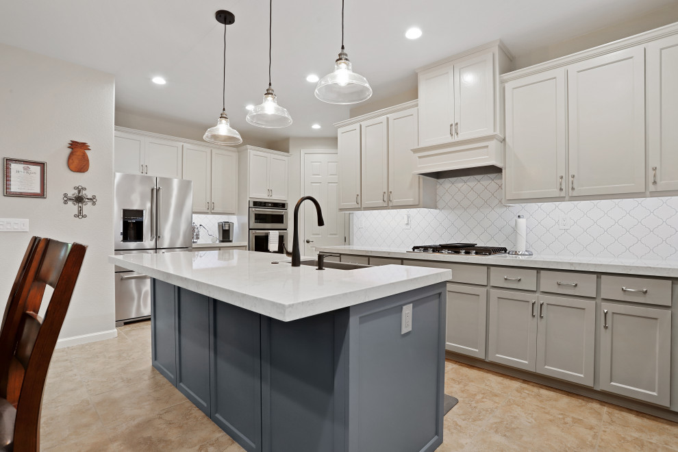 Inspiration for a modern l-shaped eat-in kitchen in Sacramento with a farmhouse sink, grey cabinets, quartz benchtops, white splashback, mosaic tile splashback, stainless steel appliances, with island and white benchtop.