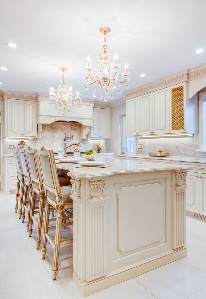This is an example of a mid-sized traditional separate kitchen in New York with raised-panel cabinets, beige cabinets, beige splashback, stone slab splashback, panelled appliances, ceramic floors, with island, white floor, an undermount sink and marble benchtops.