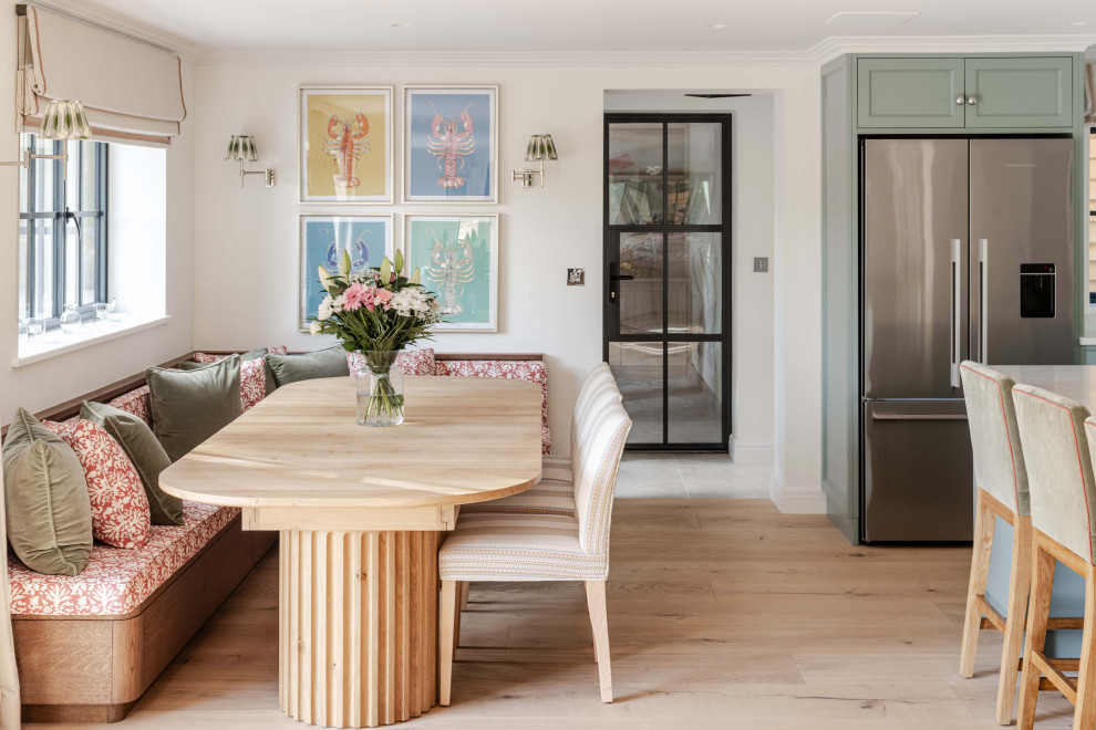 Design ideas for a large farmhouse open plan living room in Sussex with light hardwood flooring and a brick fireplace surround.