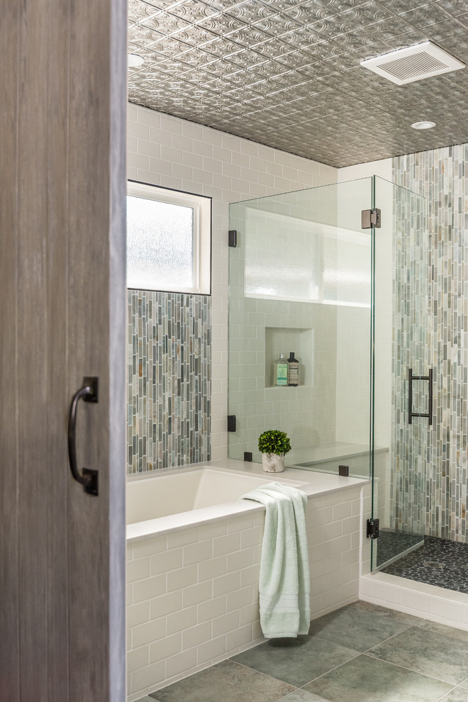 Photo of a large transitional master wet room bathroom in San Francisco with shaker cabinets, blue cabinets, an undermount tub, a two-piece toilet, green tile, slate, white walls, porcelain floors, an undermount sink, engineered quartz benchtops, green floor and a hinged shower door.