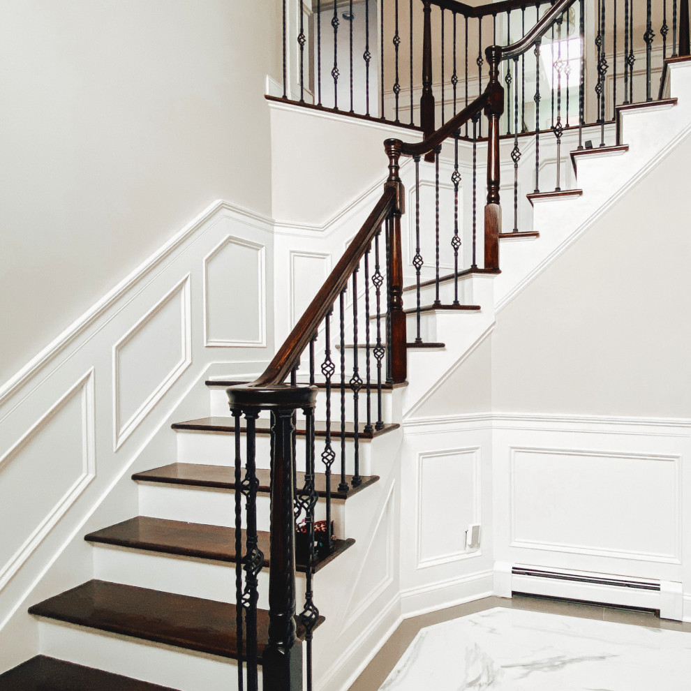 Inspiration for a large modern staircase with decorative wall panelling.