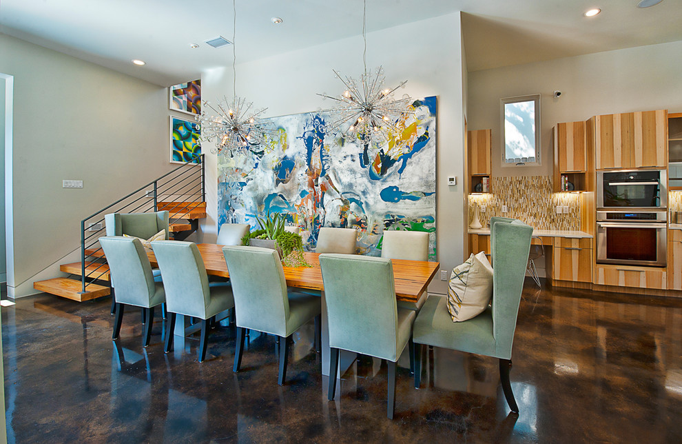 Photo of a contemporary dining room in Austin with concrete floors.