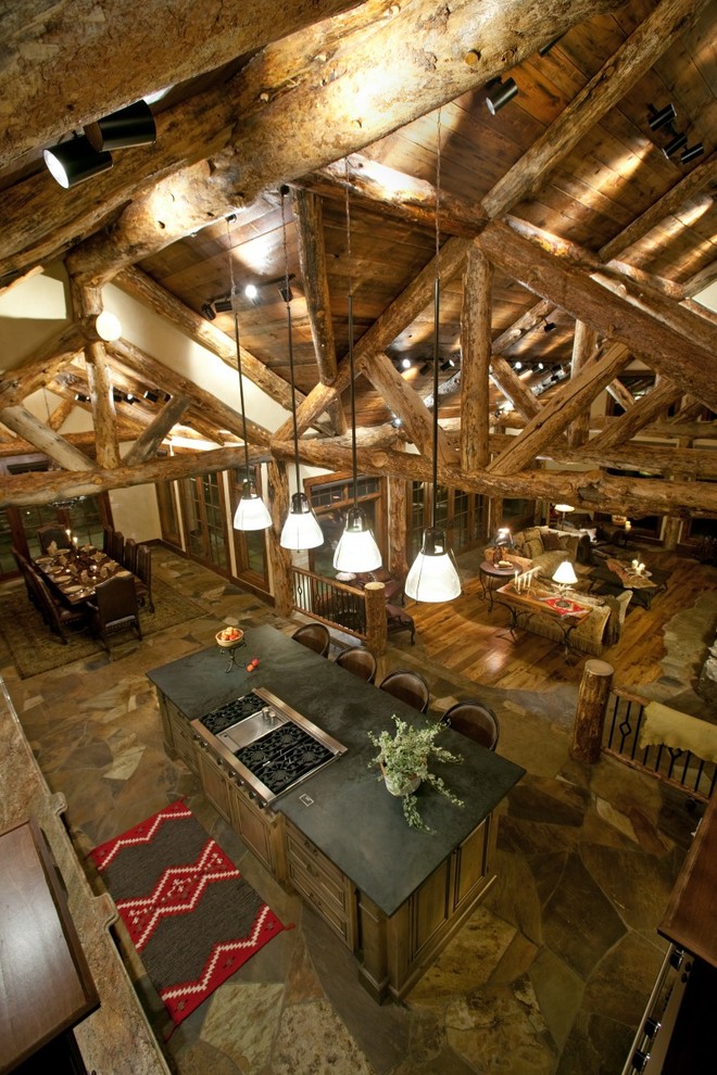 Example of a huge mountain style kitchen design in Denver with soapstone countertops and an island