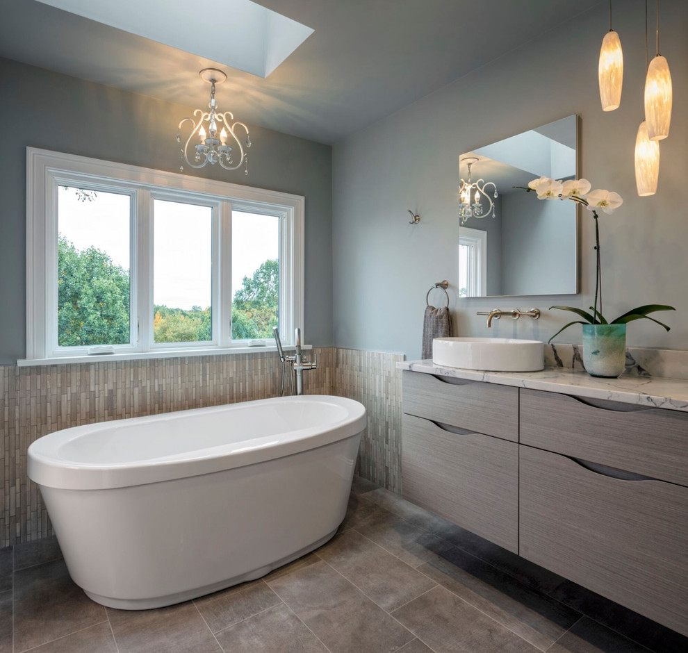 Photo of a contemporary master wet room bathroom in Bridgeport with flat-panel cabinets, grey cabinets, a freestanding tub, a one-piece toilet, black tile, slate, blue walls, ceramic floors, a vessel sink, quartzite benchtops, beige floor, an open shower and white benchtops.