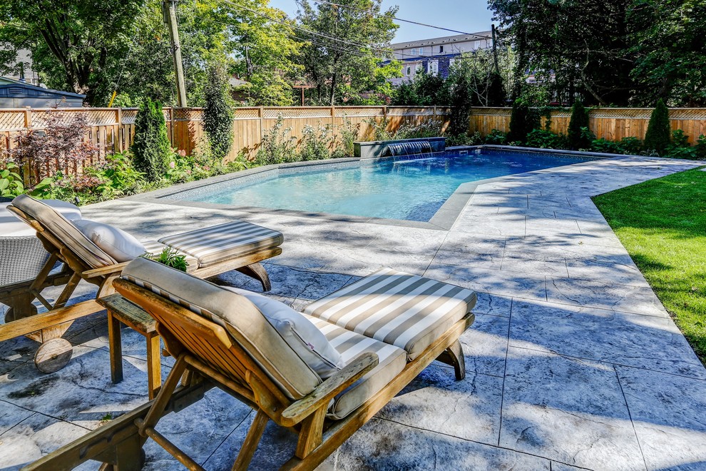 Pool - mid-sized transitional backyard stamped concrete and rectangular pool idea in Toronto