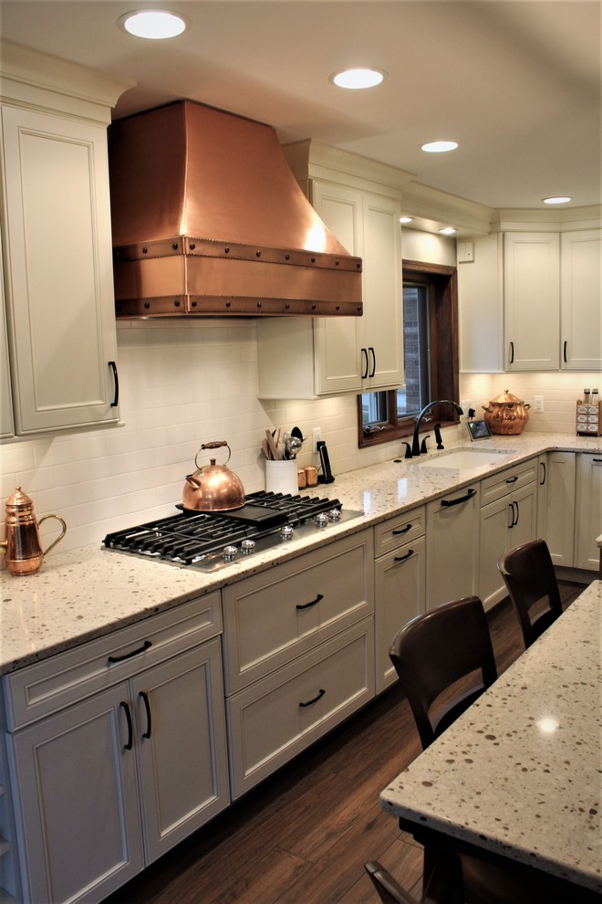 Inspiration for a mid-sized transitional l-shaped separate kitchen in Detroit with an undermount sink, recessed-panel cabinets, white cabinets, quartz benchtops, yellow splashback, ceramic splashback, stainless steel appliances, porcelain floors and with island.