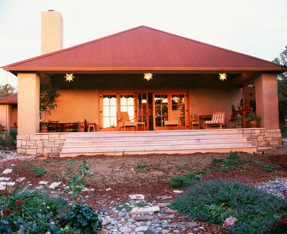 Photo of a mid-sized one-storey stucco beige exterior in Albuquerque with a hip roof.