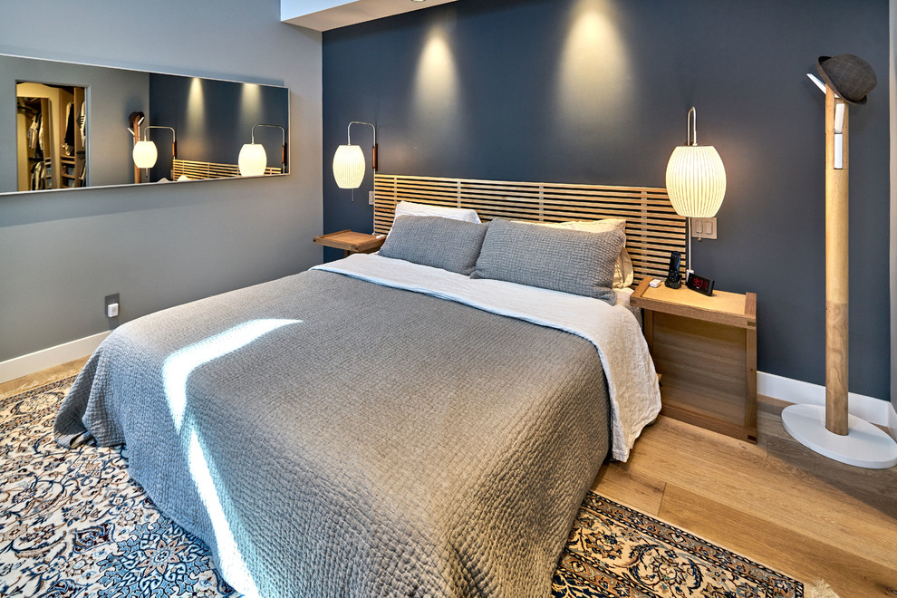 Mid-sized contemporary master bedroom in San Francisco with blue walls and light hardwood floors.