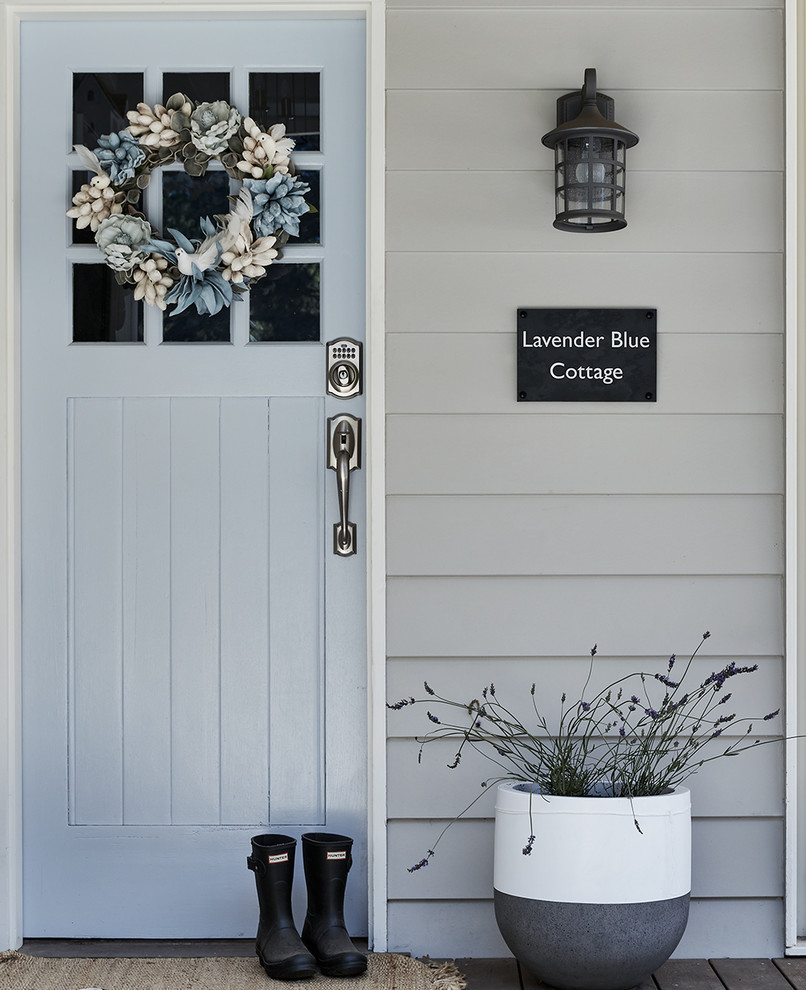 This is an example of a country front door in Melbourne with grey walls, a single front door and a blue front door.