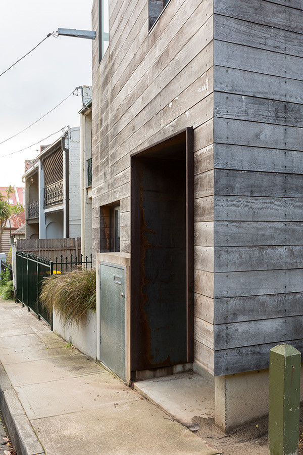 Design ideas for a contemporary two-storey grey exterior in Sydney with wood siding.