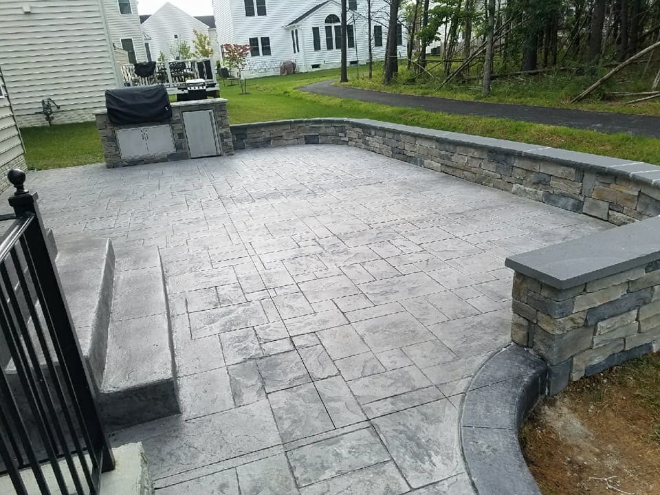 R Stamped Concrete Patio Seating Wall With Flagstone Caps And