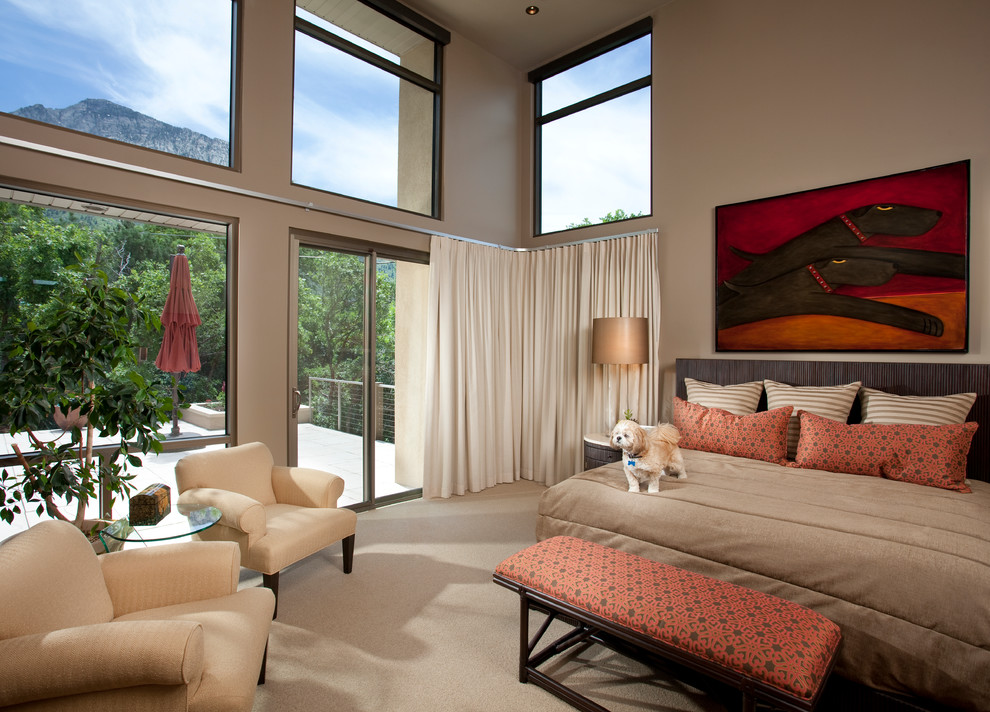 Photo of a contemporary master bedroom in Salt Lake City with brown walls and carpet.