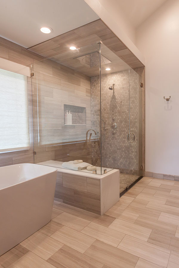 This is an example of an expansive contemporary master bathroom in Los Angeles with flat-panel cabinets, dark wood cabinets, a freestanding tub, a corner shower, gray tile, mosaic tile, multi-coloured walls, light hardwood floors, a trough sink, engineered quartz benchtops, brown floor and a hinged shower door.