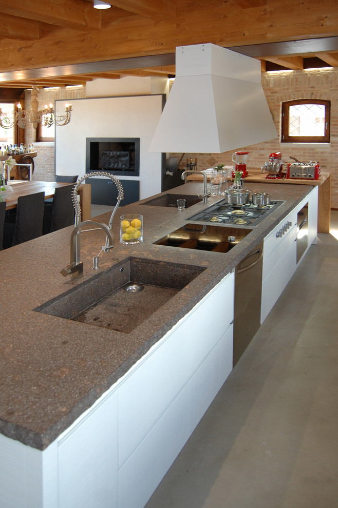 Inspiration for a large country single-wall eat-in kitchen in Venice with an undermount sink, flat-panel cabinets, white cabinets, limestone benchtops, stainless steel appliances, concrete floors, no island, brown floor and multi-coloured benchtop.