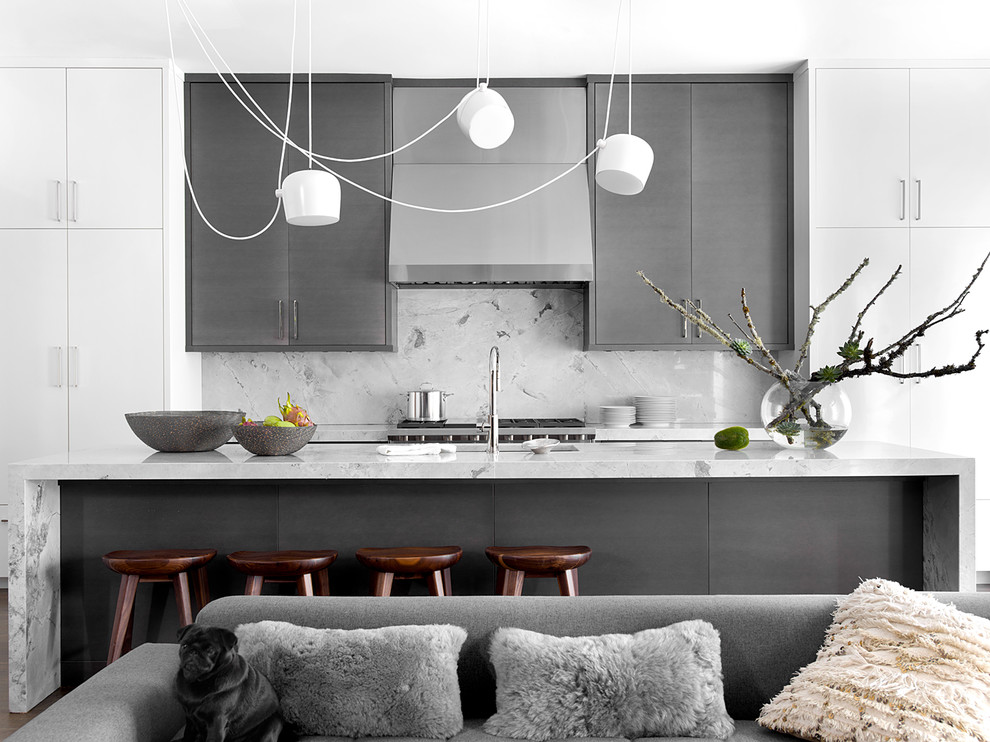 Inspiration for a contemporary open plan kitchen in Chicago with an undermount sink, flat-panel cabinets, grey cabinets, grey splashback, stone slab splashback, with island and grey benchtop.
