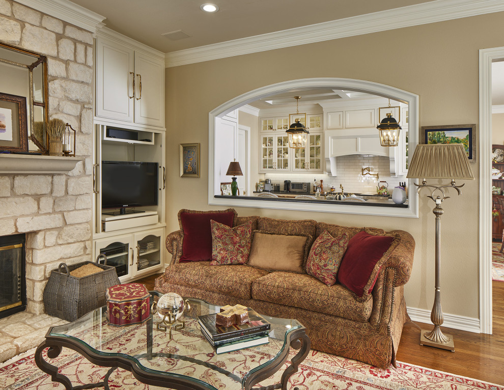 Inspiration for a traditional living room in Dallas with a standard fireplace, a stone fireplace surround and a corner tv.