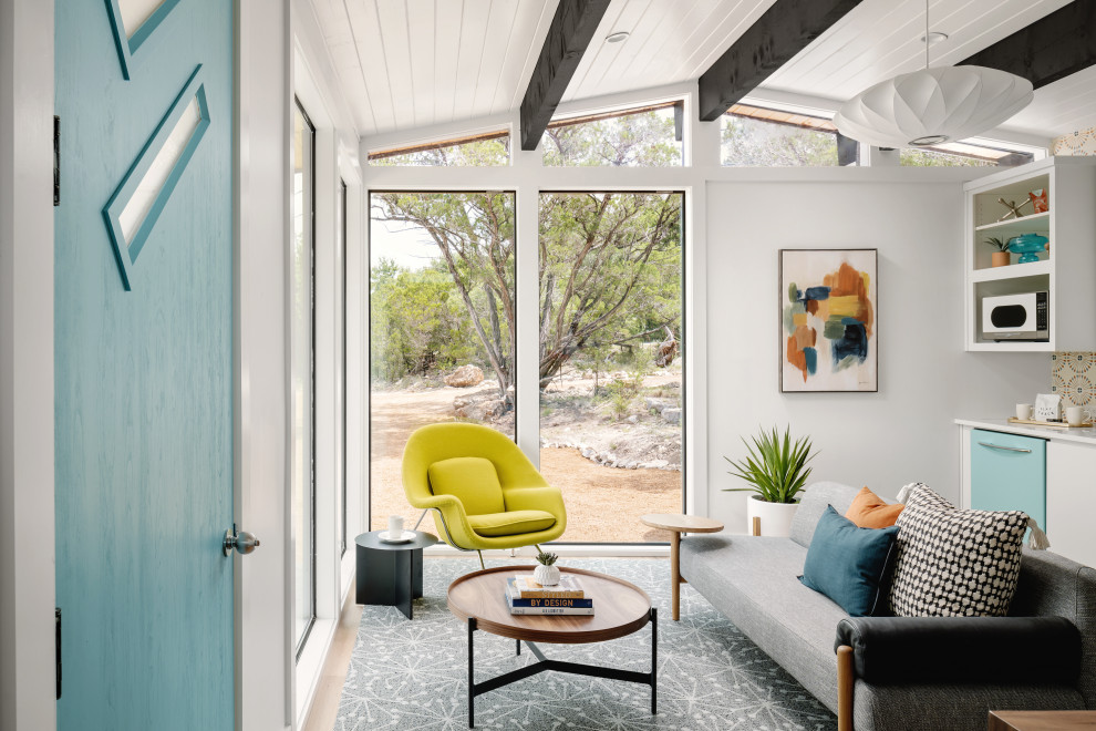 Inspiration for a small midcentury open plan living room in Austin with white walls, medium hardwood flooring, a standard fireplace and a wood ceiling.