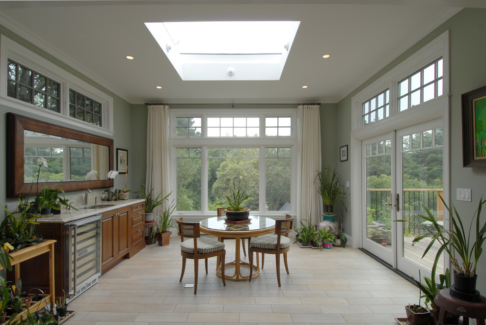 This is an example of a large traditional sunroom in San Francisco with ceramic floors, no fireplace, a standard ceiling and beige floor.