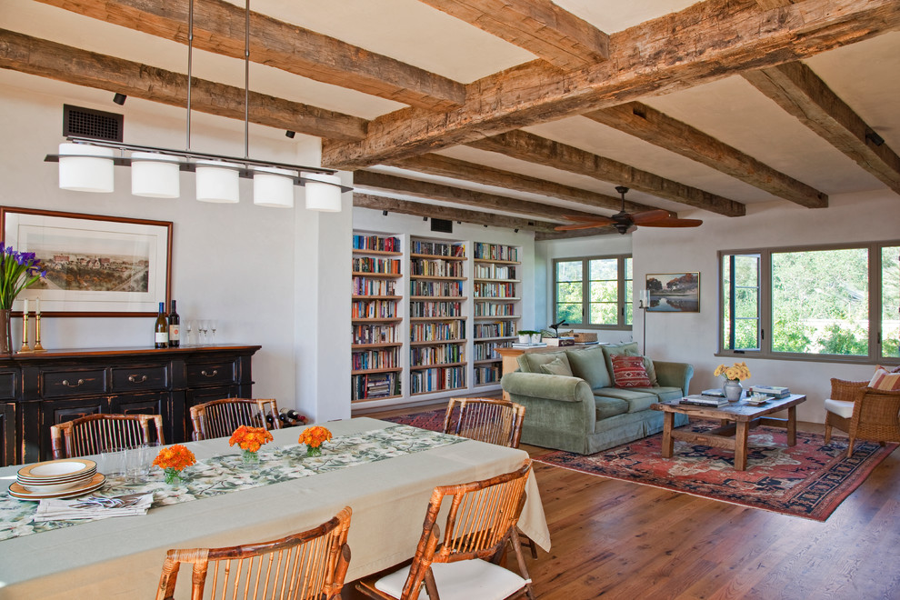 Mid-sized mediterranean open concept living room in Santa Barbara with a library, white walls and medium hardwood floors.
