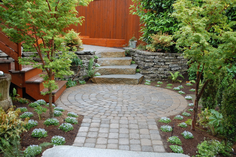 This is an example of a contemporary garden in Seattle with brick pavers.