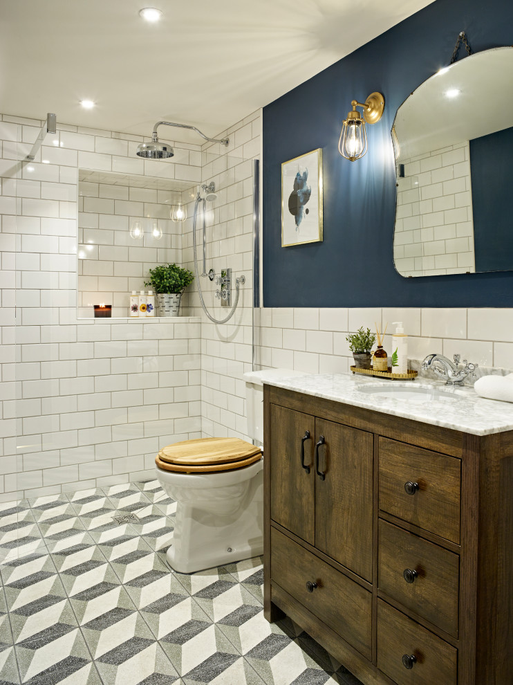 Inspiration for a traditional bathroom in Kent with flat-panel cabinets, dark wood cabinets, a curbless shower, white tile, blue walls, cement tiles, an undermount sink, multi-coloured floor, an open shower and white benchtops.