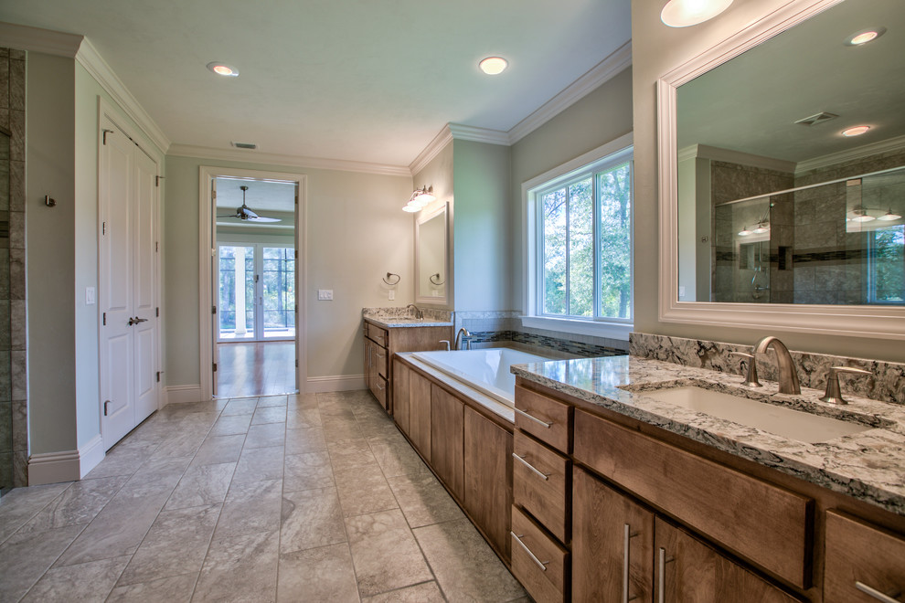 Expansive transitional master bathroom in Atlanta with flat-panel cabinets, medium wood cabinets, a drop-in tub, multi-coloured tile, matchstick tile, blue walls, vinyl floors, an undermount sink, granite benchtops, a curbless shower and a two-piece toilet.