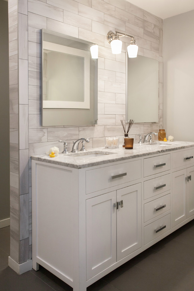 Bathroom - small transitional kids' gray tile and porcelain tile ceramic tile and gray floor bathroom idea with flat-panel cabinets, white cabinets, beige walls, marble countertops and an undermount sink