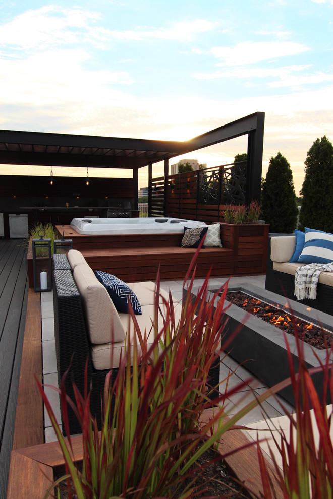 Large contemporary rooftop deck in Chicago with a container garden and a pergola.