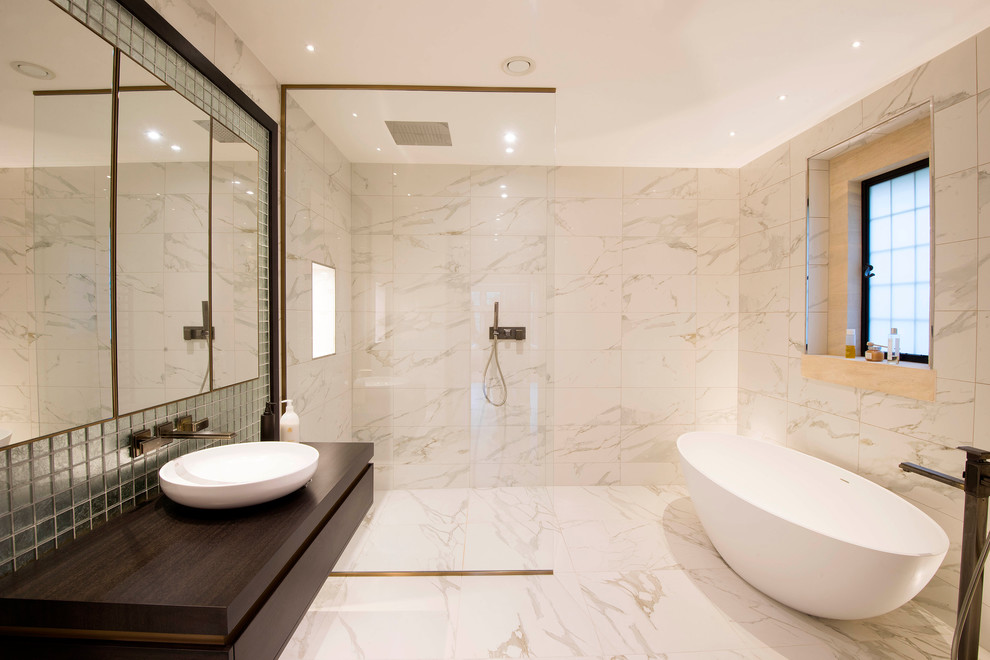 Inspiration for a large contemporary master wet room bathroom in Cheshire with recessed-panel cabinets, a freestanding tub, white tile, marble, white walls, marble floors, a pedestal sink, wood benchtops, white floor, an open shower and brown benchtops.