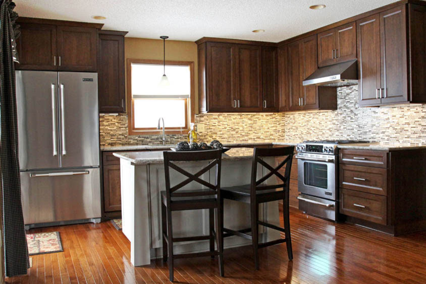 Example of a large transitional l-shaped dark wood floor and brown floor open concept kitchen design in Orange County with an undermount sink, stainless steel appliances, an island, shaker cabinets, dark wood cabinets, granite countertops, beige backsplash and matchstick tile backsplash