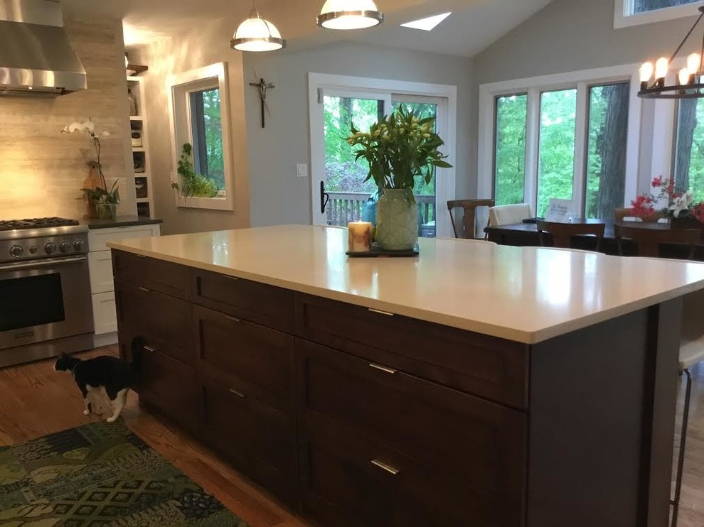 Large midcentury eat-in kitchen in DC Metro with glass-front cabinets, white cabinets, stainless steel appliances, light hardwood floors and with island.
