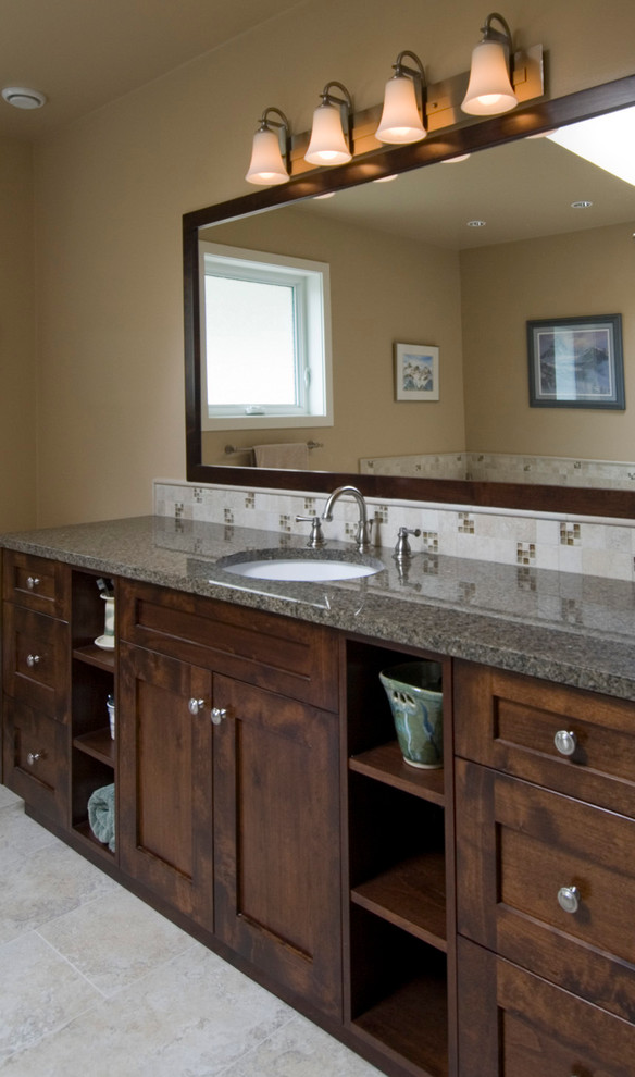 Photo of a large traditional master bathroom in Vancouver with an undermount sink, shaker cabinets, medium wood cabinets, granite benchtops, a drop-in tub, a corner shower, a two-piece toilet, beige tile, porcelain tile, brown walls and porcelain floors.