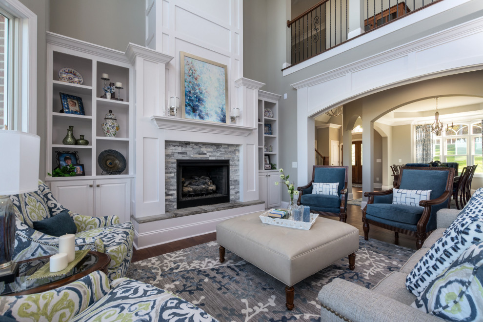 Traditional formal open concept living room in Other with grey walls, medium hardwood floors, a standard fireplace, a tile fireplace surround, no tv and brown floor.