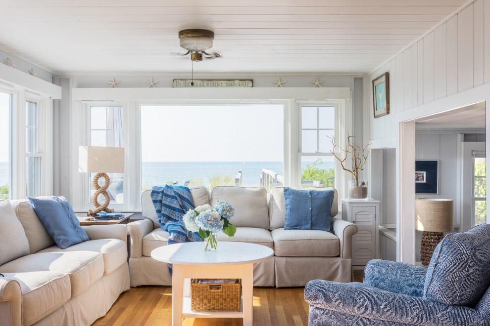 Photo of a mid-sized beach style enclosed living room in Boston with grey walls and beige floor.