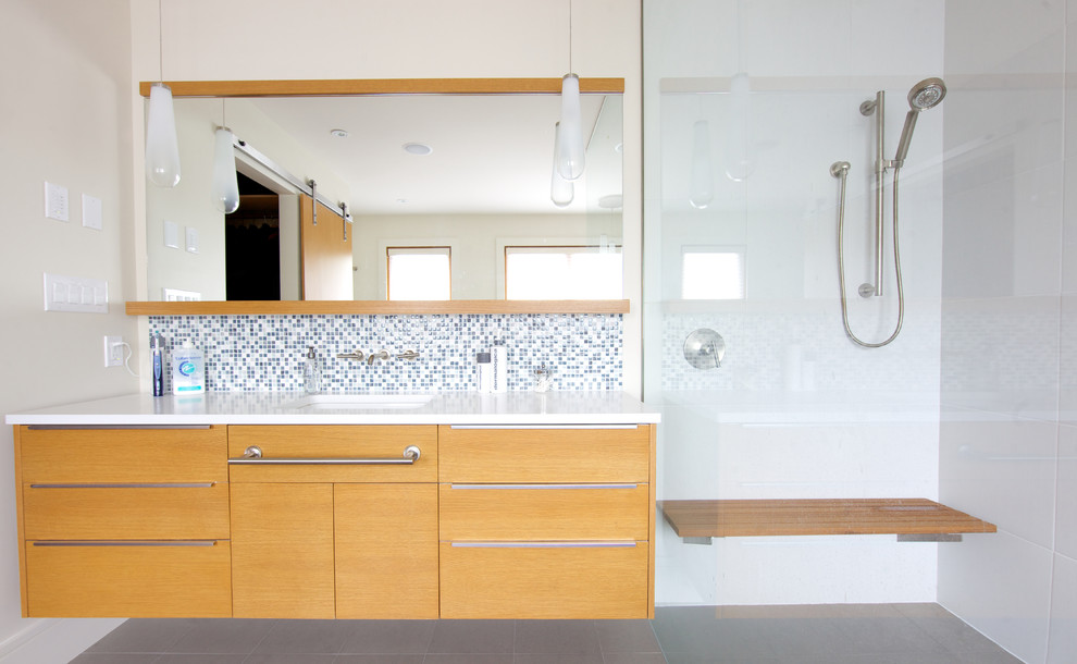 Expansive contemporary master bathroom in Vancouver with an undermount sink, flat-panel cabinets, light wood cabinets, gray tile, engineered quartz benchtops, a curbless shower, porcelain tile, white walls and porcelain floors.