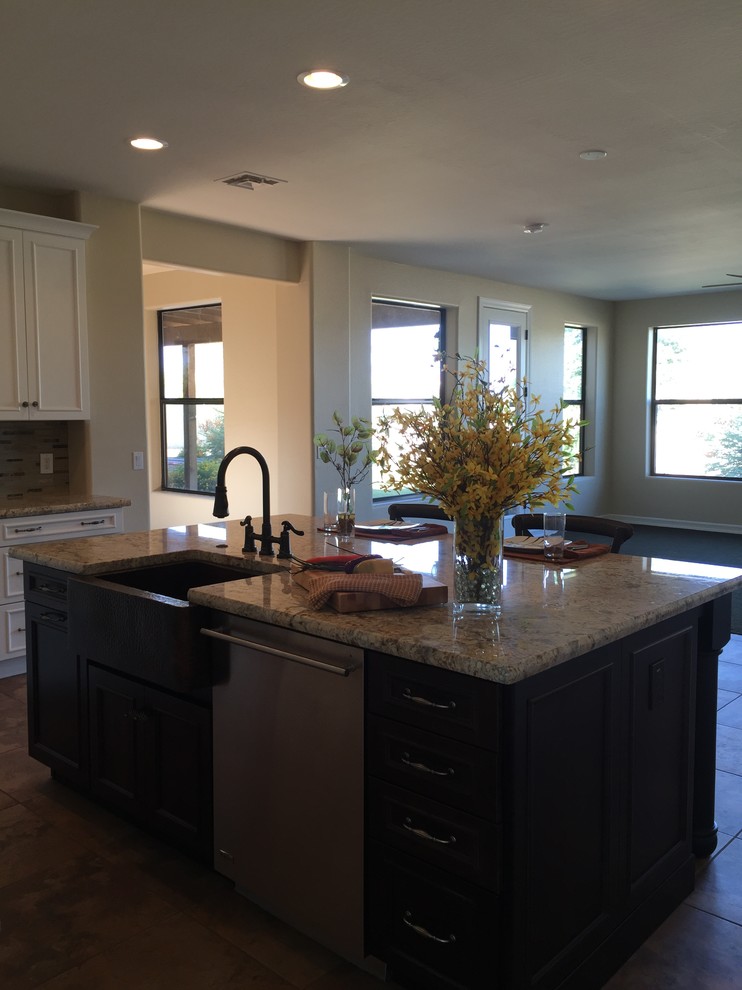 Example of a large transitional eat-in kitchen design in Phoenix with granite countertops, gray backsplash, stone tile backsplash, black appliances and an island