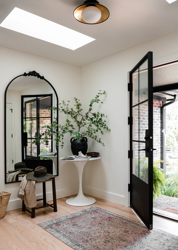 Front door - mid-sized transitional light wood floor front door idea in Chicago with white walls and a black front door