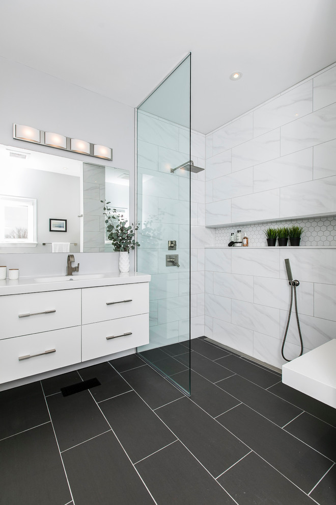 Inspiration for a mid-sized modern master bathroom in Ottawa with flat-panel cabinets, white cabinets, an open shower, a one-piece toilet, white tile, porcelain tile, an integrated sink, an open shower and white benchtops.