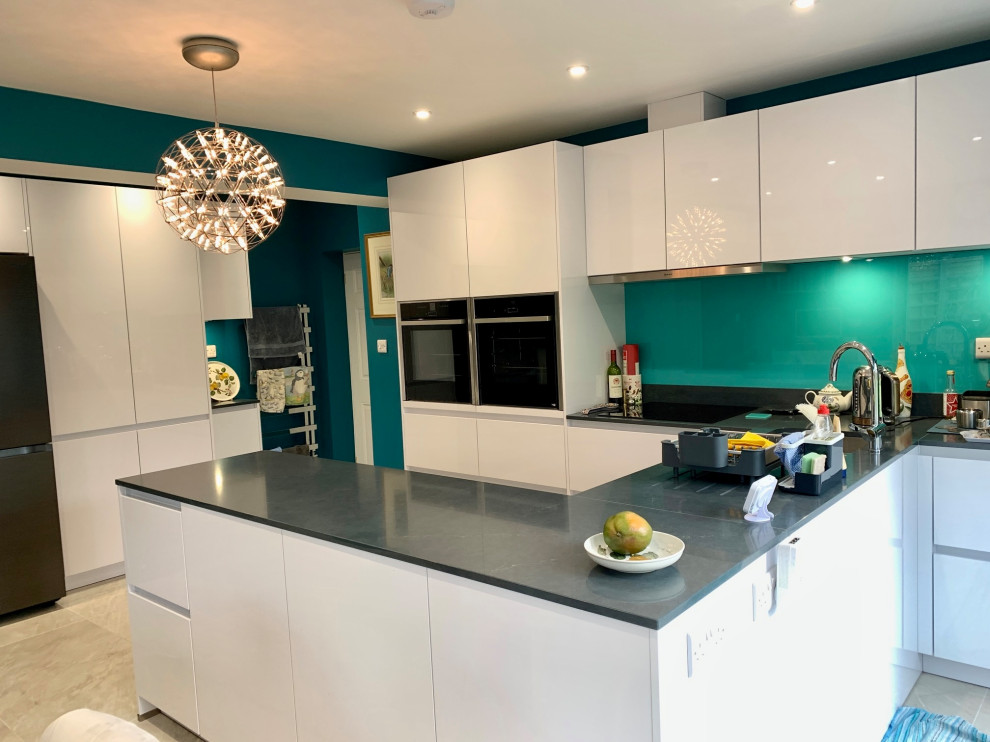 Design ideas for a medium sized u-shaped kitchen/diner in Berkshire with flat-panel cabinets, white cabinets, quartz worktops and grey worktops.