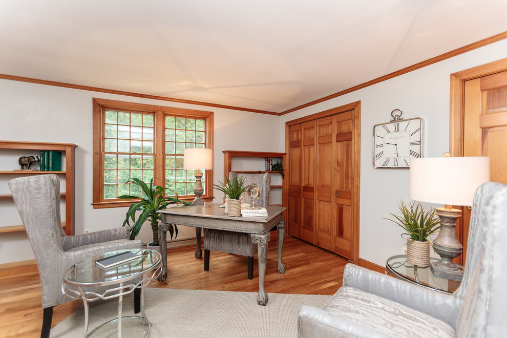 Mid-sized traditional study room in Boston with white walls, medium hardwood floors and a freestanding desk.