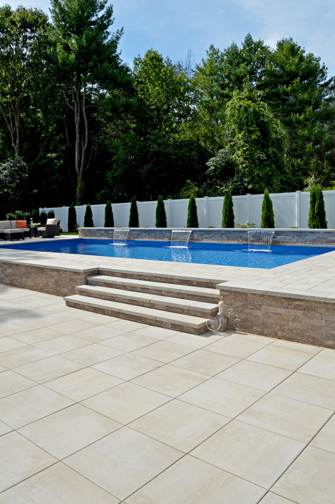 Traditional backyard custom-shaped aboveground pool in New York with brick pavers.