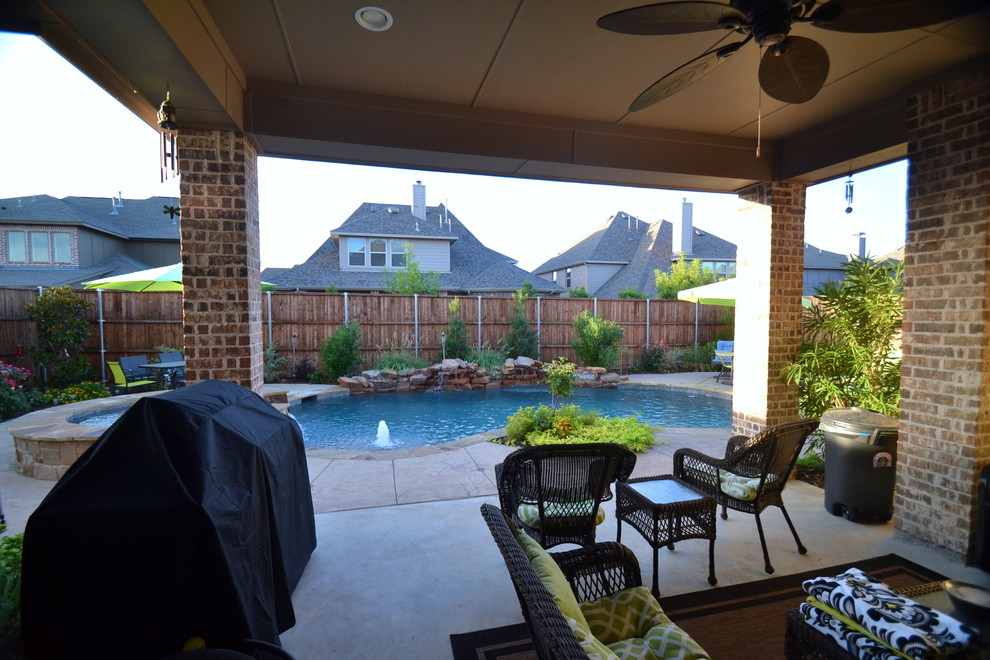 This is an example of a small country backyard custom-shaped pool in Dallas.