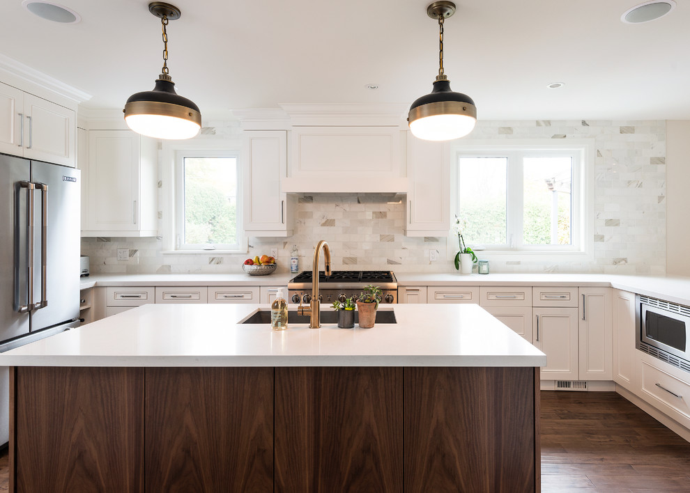 This is an example of a mid-sized contemporary l-shaped open plan kitchen in Toronto with a single-bowl sink, recessed-panel cabinets, white cabinets, quartzite benchtops, white splashback, stone tile splashback, stainless steel appliances, medium hardwood floors and with island.