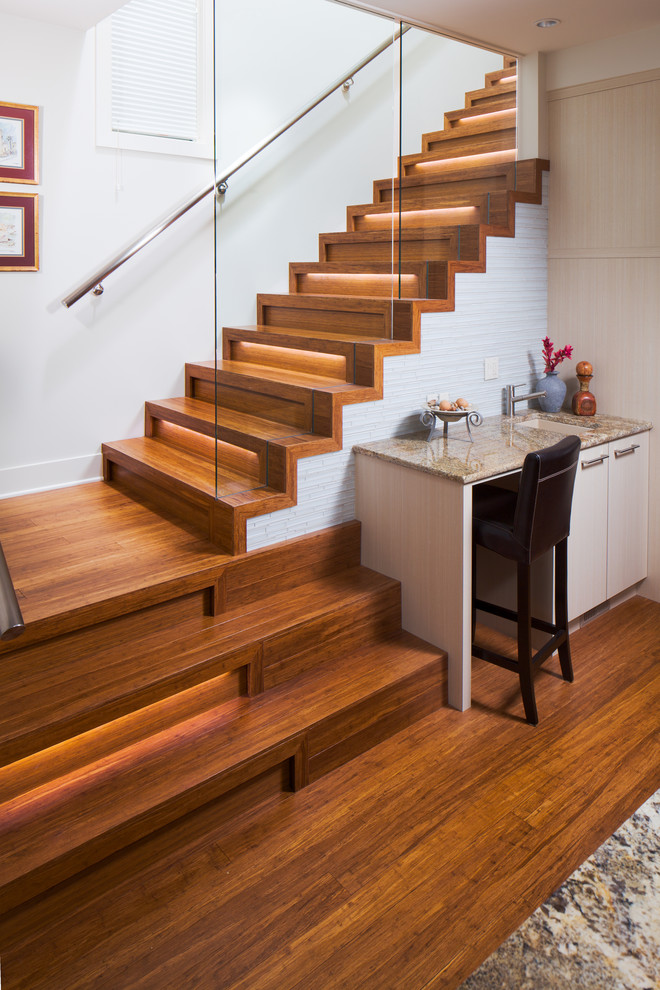 Design ideas for a mid-sized contemporary wood l-shaped staircase in Calgary with wood risers and metal railing.