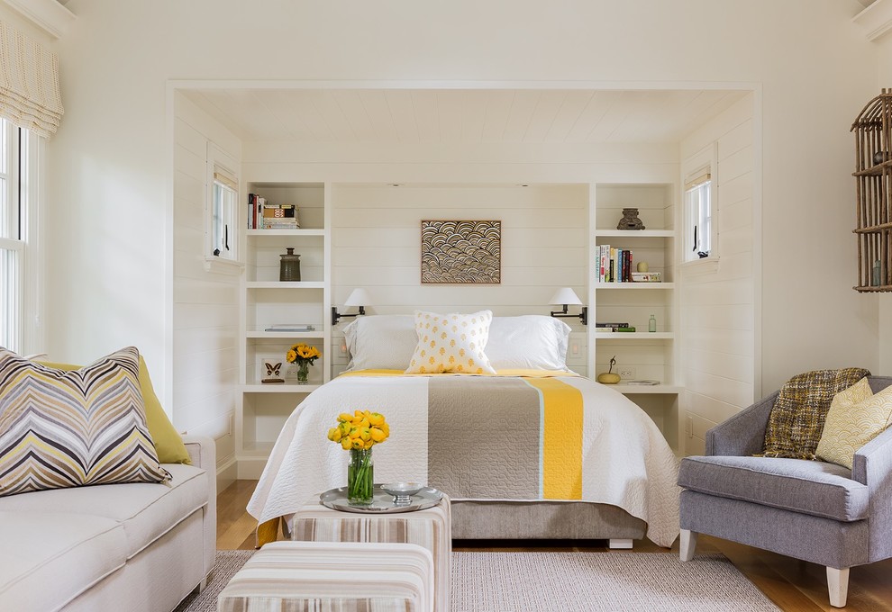Design ideas for a mid-sized beach style guest bedroom in Boston with white walls and medium hardwood floors.